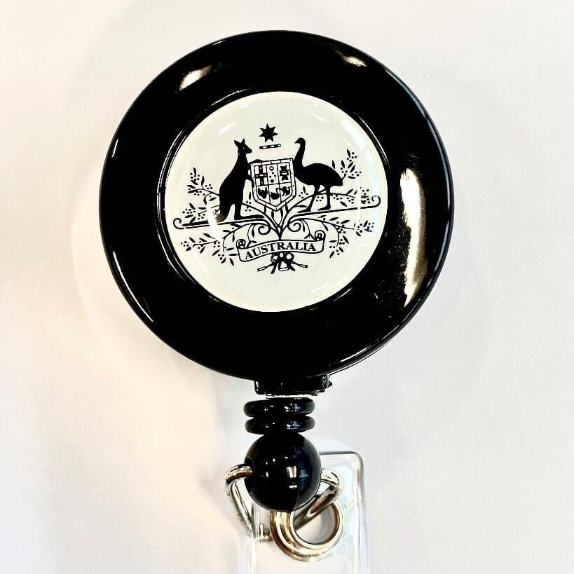Aust. Coat of Arms Reel with Belt Clip & Strap Clip (86cm nylon cord with strap & an epoxy dome with the Australian Coat of Arms logo printed & "100% RECYCLED PLASTIC MATERIAL" on the back.